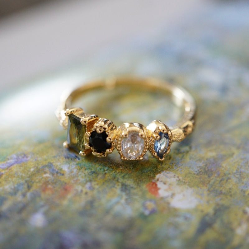 Close-up of RosyCozy Enchanted Garden ring with vibrant gemstones and vintage-style setting