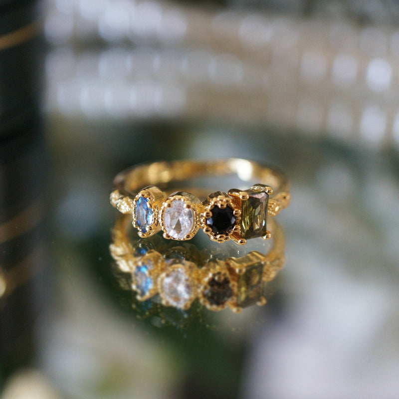 Close-up of RosyCozy Enchanted Garden ring with vibrant gemstones and vintage-style setting