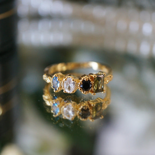 Close-up of RosyCozy Enchanted Garden ring with vibrant gemstones and vintage-style setting