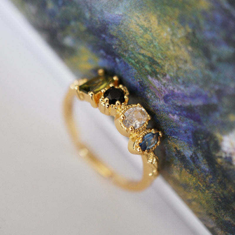 Close-up of RosyCozy Enchanted Garden ring with vibrant gemstones and vintage-style setting