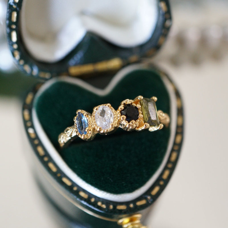 Close-up of RosyCozy Enchanted Garden ring with vibrant gemstones and vintage-style setting