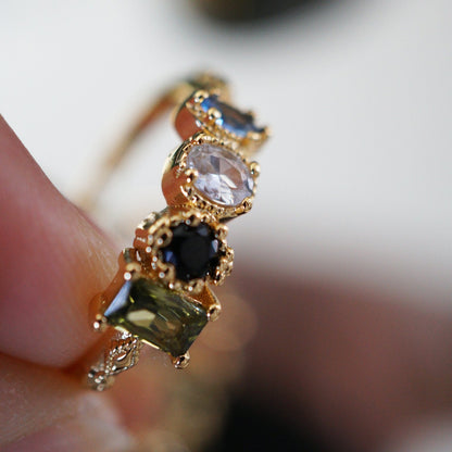 Close-up of RosyCozy Enchanted Garden ring with vibrant gemstones and vintage-style setting