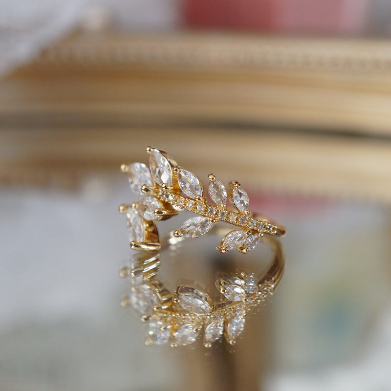 Gold leaf vine ring with marquise-cut zircon gemstones on an 18k gold-plated band