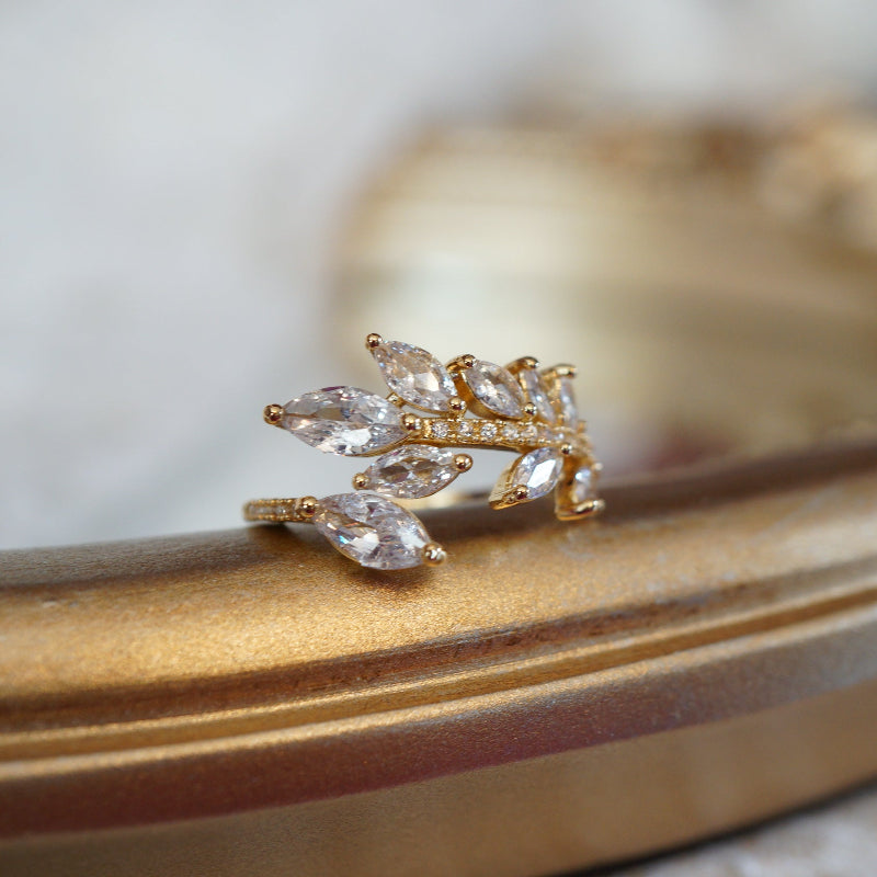 Gold leaf vine ring with marquise-cut zircon gemstones on an 18k gold-plated band