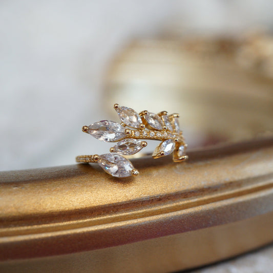 Gold leaf vine ring with marquise-cut zircon gemstones on an 18k gold-plated band