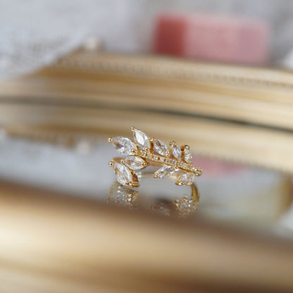 Gold leaf vine ring with marquise-cut zircon gemstones on an 18k gold-plated band