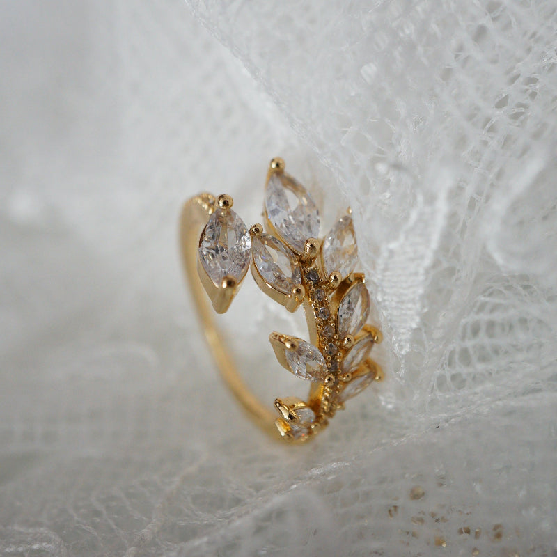 Gold leaf vine ring with marquise-cut zircon gemstones on an 18k gold-plated band