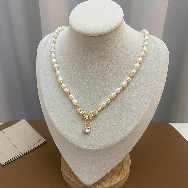 Elegant RosyCozy necklace featuring butterfly teardrop pendant and natural freshwater pearl
