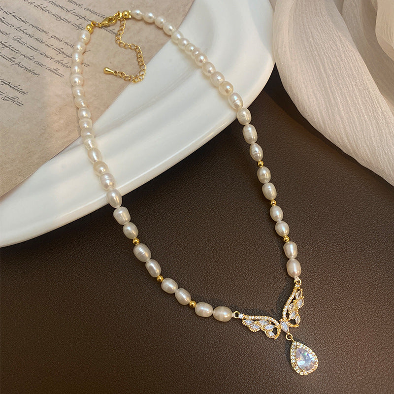 Elegant RosyCozy necklace featuring butterfly teardrop pendant and natural freshwater pearl